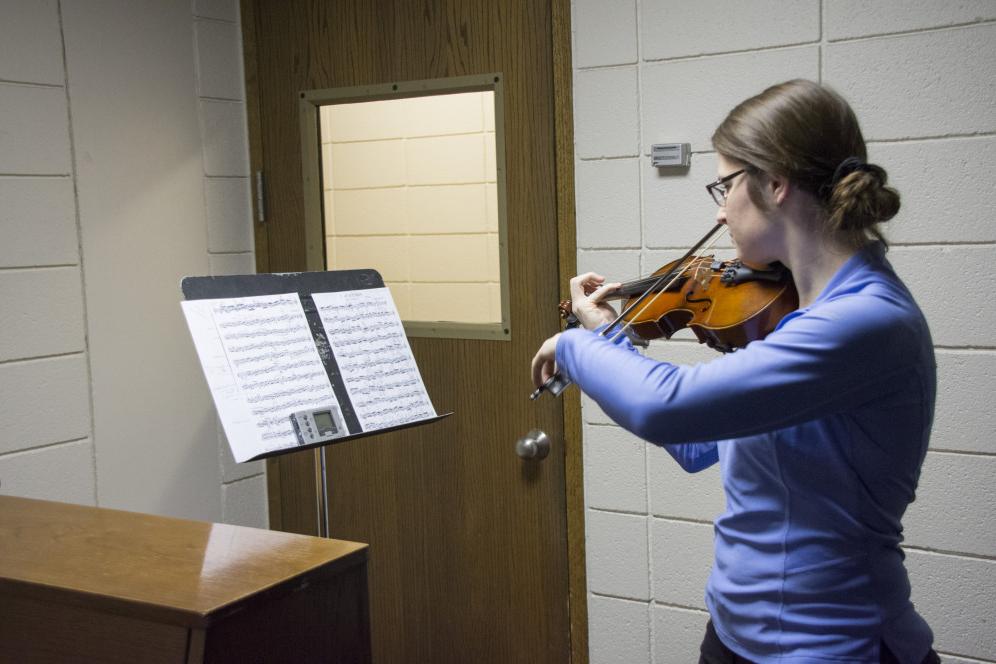 A student practicing in one of the Practice Rooms in the H. F. Johnson Center for the Arts.